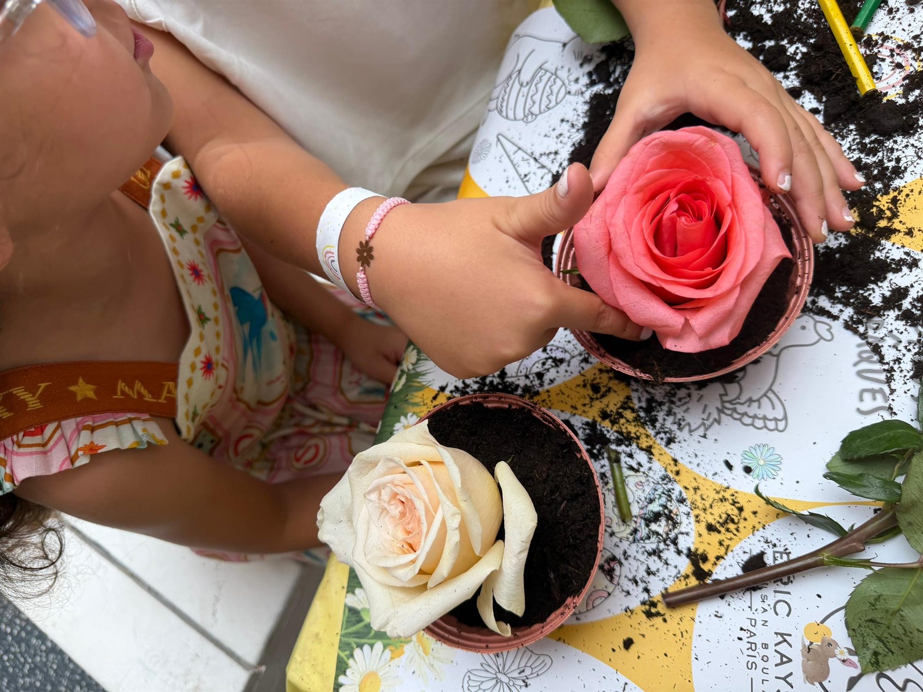 Children arranging fresh roses at a Kidkit workshop